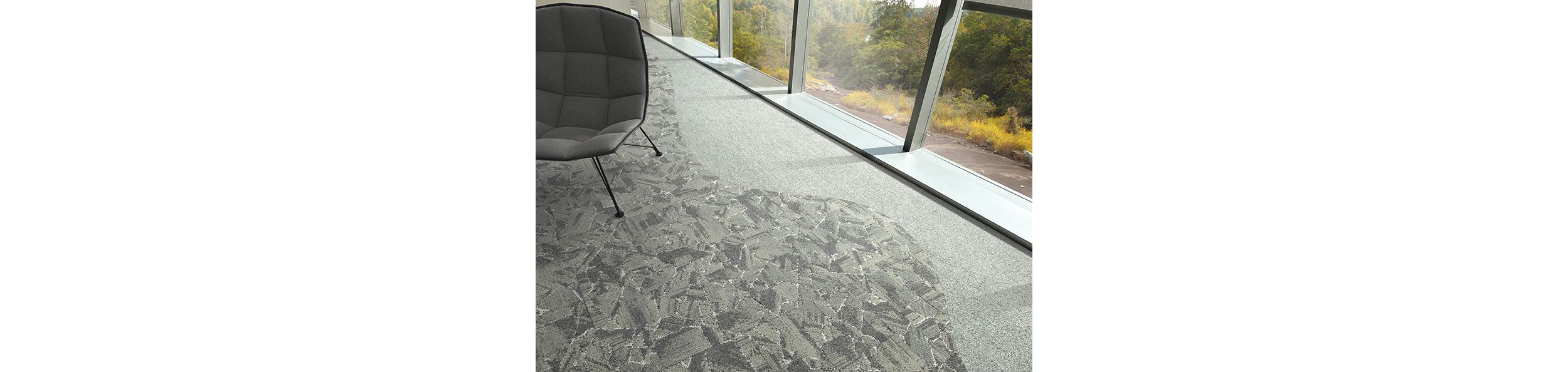 Interface Mile Rock carpet tile and Rockland Road plank carpet tile in close up with grey chair image number 3